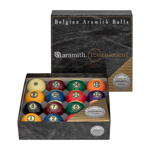 A boxed set of Belgian Aramith balls for billiards, shown open with the lid standing behind it on a white background. The set includes numbered balls in multiple colors inside a dark gray marbled presentation box with gold text and seal graphics.