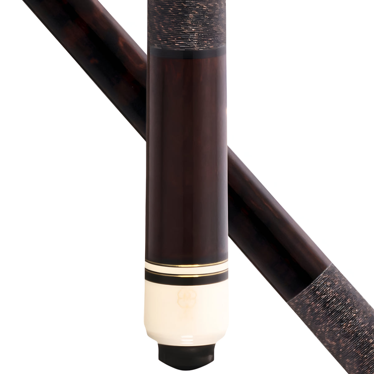 Close-up of a billiards cue stick showing the dark brown wood shaft, a cream-colored butt, and a black tip, with a second diagonal view of the shaft in the background.