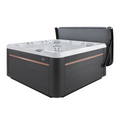 Caldera ProLift III cover lifter holding a dark hot tub cover upright behind an open spa